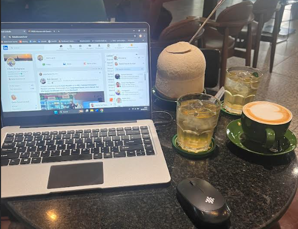 Games copywriting in a cafe can be thirsty work. Image of Chris's writing laptop and several drinks.